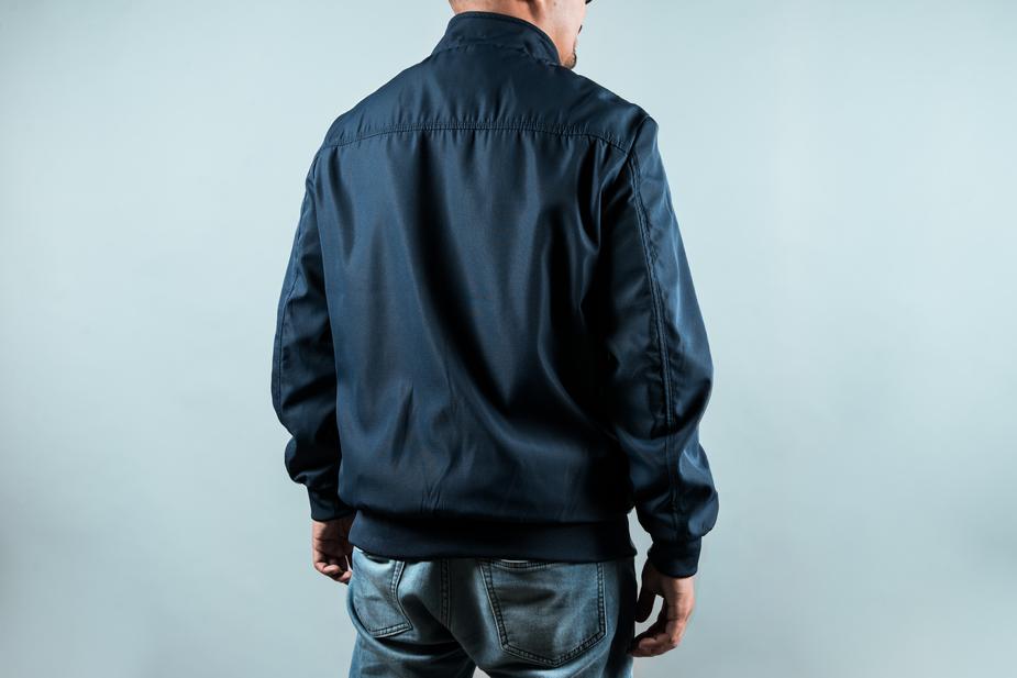 a man with a backpack is standing on a bench