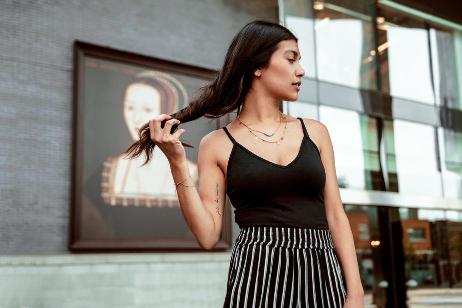 a woman in a dress standing in front of a building