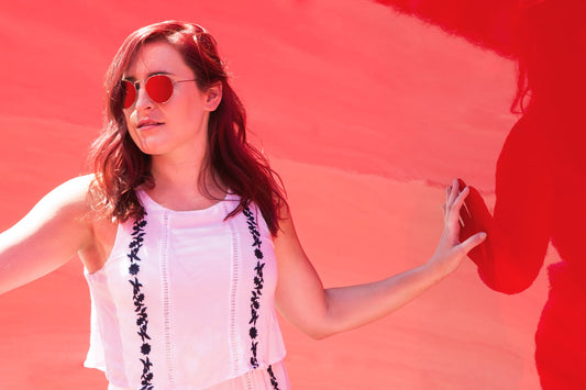 a woman in a pink dress holding a cell phone 
