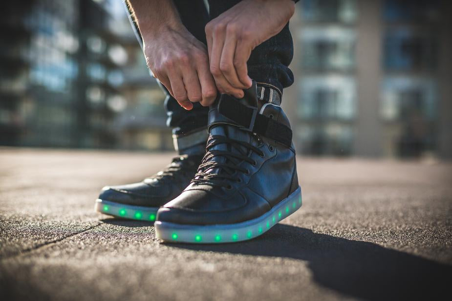 a person standing on a skateboard on a sidewalk 